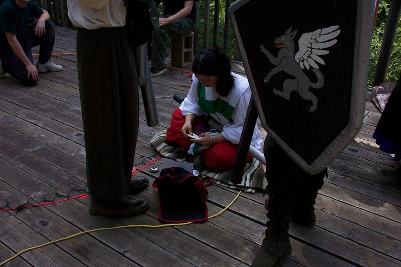 Liandrin prepares her scrolls and components for the formal magic.