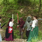 Beryl, Liandrin, and Valia face off against a fire elemental and a gnoll.